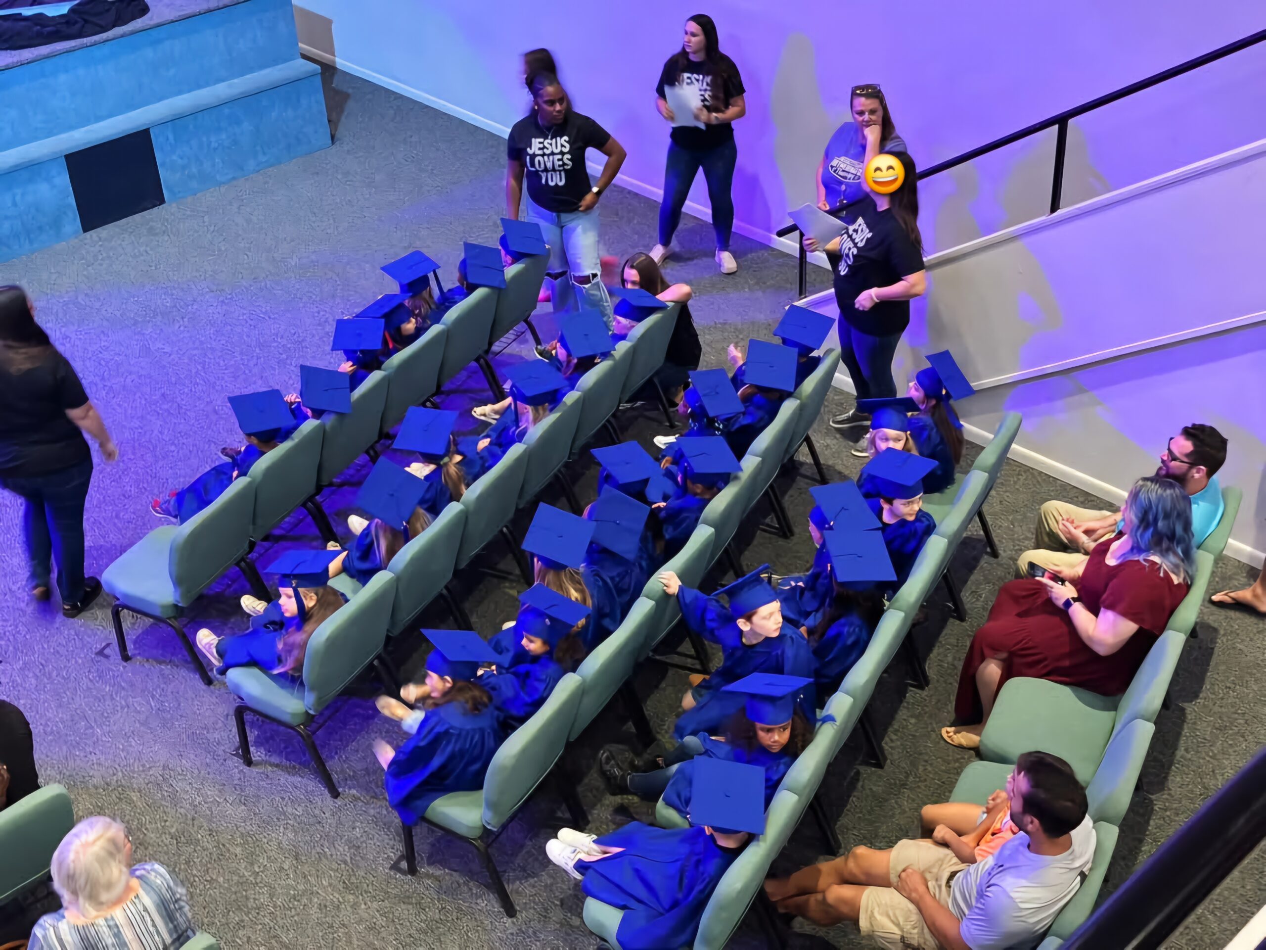 Preschool students in blue graduation caps and gowns sitting in rows during a Bethany Christian Preschool ceremony at Bethany Church.